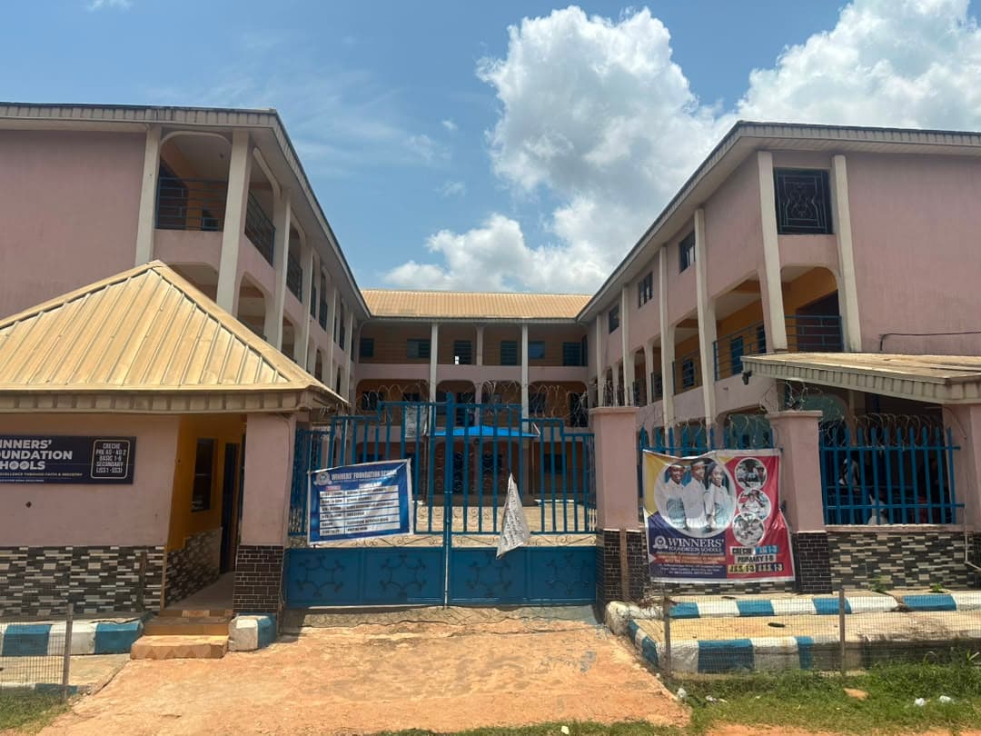 Front view of Winners' Foundation School campus gate and buildings